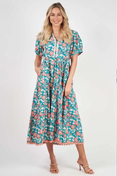 Impress the crowd at your next special event wearing this elegant new Frida Maxi featuring featuring the exquisite coral florals and contrasting aqua of our Seville Print. The delicate sequinned trim down the front of the bodice and feminine, tiered, skir