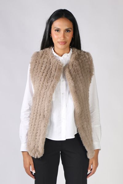 Add a little glamour to your outfits with this faux fur vets from Jump. Featuring an open waterfall style front, this sleeveless vest is perfect for layering over dresses or shirts and pants alike! Style 4611097A.