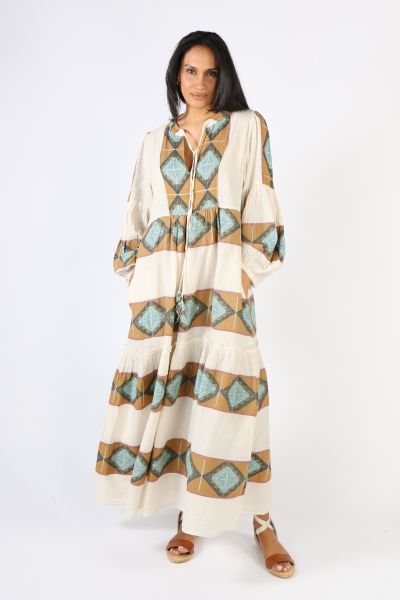 The Zakar Maxi Dress will have you feeling like a Greek Goddess. This garment is 100% cotton. The dress has a v neck with a self tie that may be tied up or worn lose to the front of the garment. Featuring a full length sleeve and maxi length, in tones of 