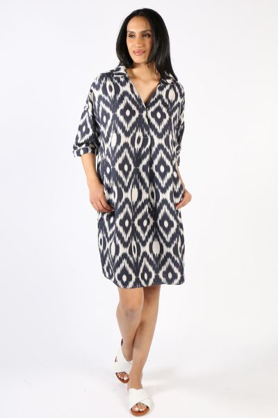 An easy summer dress by Ping Pong is a head turner for all the right reasons. In a V neck, the front pleated dress features an overall ikat print in 100% Linen. The boxy dress has short sleeves and knee length dress can be styled with easy slides or sneak