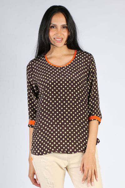 Anupamaa Pure Silk Hand Block Sarine Top, with a polka dot print, round neck and long sleeves which have striped contrasting detail on the neckline and wrist line. This Regular Fit top with a round neck and full sleeves, looks fabulous with your favorite 