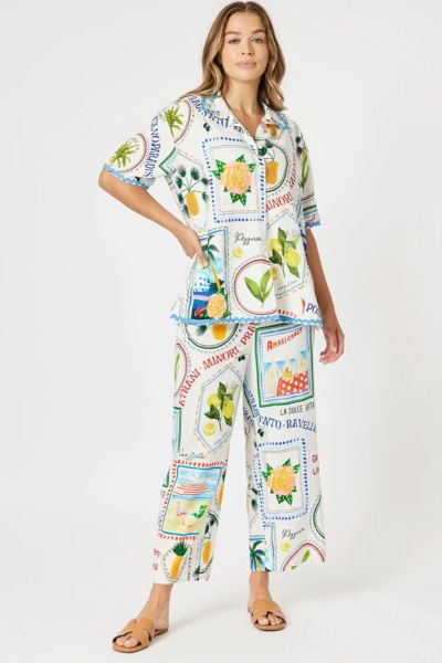 Celebrate la dolce vita in style with The Amalfi Pant, inspired by the charm and colour of the Italian coastline. Featuring a playful postcard and stamp print with limes, beach umbrellas, and coastal motifs, these pants bring the spirit of summer holidays