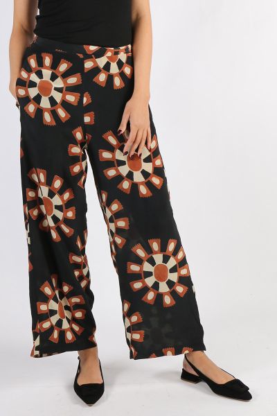Anupamaa Pure Silk Hand Block Print Palazzo Pant, has white stripe detail on the elasticised waist and the underside of the hemline and has side pockets. For Summer in the city and a fresh look team with white Shirt, and ultra flat tan sandal. Perfect for