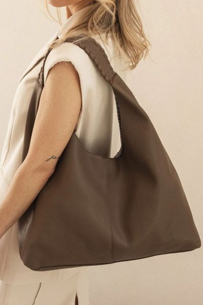 The Louenhide Avery Shoulder Bag is a modern take on the classic hobo bag with an elevated twist. The whipstitch detailing adds depth and texture to the shoulder bags exterior while the slouchy, minimalistic design adds a soft yet sleek element to your ca