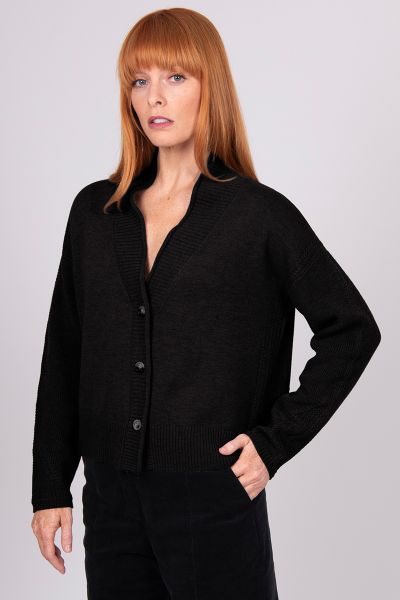 A Boxy fit relaxed cardigan with ribbed shawl collar and detailed, cable panel feature. Dropped shoulders for an easy to wear, relaxed look. High hip length. The collar can be worn high or folded for a roll collar effect. Horn-look buttons for a stylish f