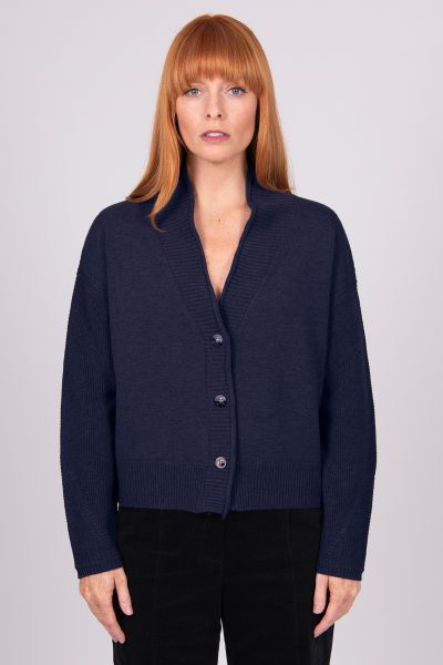 A Boxy fit relaxed cardigan with ribbed shawl collar and detailed, cable panel feature. Dropped shoulders for an easy to wear, relaxed look. High hip length. The collar can be worn high or folded for a roll collar effect. Horn-look buttons for a stylish f