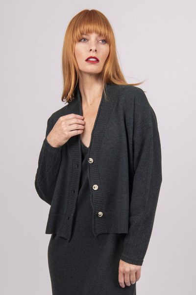 A Boxy fit relaxed cardigan with ribbed shawl collar and detailed, cable panel feature. Dropped shoulders for an easy to wear, relaxed look. High hip length. The collar can be worn high or folded for a roll collar effect. Horn-look buttons for a stylish f