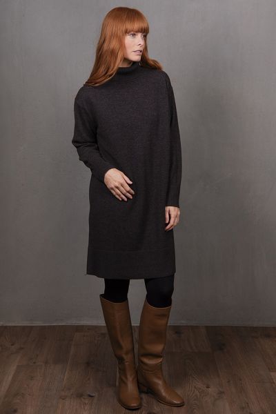 The Sweater Dress a quintessential piece of cozy sophistication designed to elevate your seasonal wardrobe. This elegantly simple dress combines structure with softness, offering a flattering silhouette that drapes effortlessly from shoulder to hem. Ideal