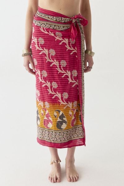 A deep carmine red sets the base for this lightweight cotton pareo, accented with intricate ivory florals and detailed black and gold borders. A subtle saffron gradient at the hem adds depth, giving the piece a rich, lived in feel. Designed for versatilit