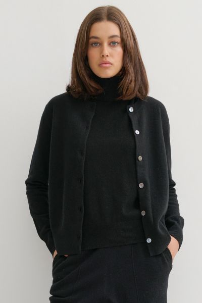 Crafted from pure, raw cashmere fibers, sustainably sourced , this essential cardigan epitomises eco luxury at its finest. This cardigan is the ultimate wardrobe essential, offering unparalleled comfort and timeless style. Its classic crew neck and delica