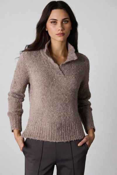 The Cellar Sweater, crafted from a soft wool alpaca blend, delivers ultimate coziness. Featuring a classic placket neckline and contrast fishbone embroidery along the side seams, this timeless piece combines warmth with subtle detailing for an effortless 