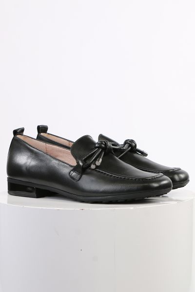 An elegant square toe moccasin made from a soft leather upper with a leather bow embellishment over the instep. Slip on and off with ease. Perfect for work, or for an elevated casual look. European sizing. Made in Spain. Leather upper, microfibre lining, 