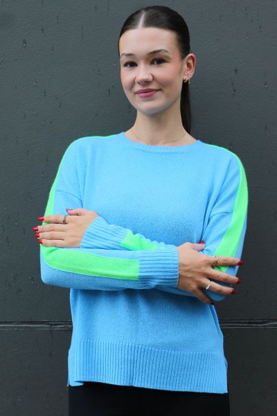 A striking jumper in cashmere by Sophie Moran is a perfect go to for the season. The bright blue is accented with green stripe detail along the arms. Style it with easy denims. 
