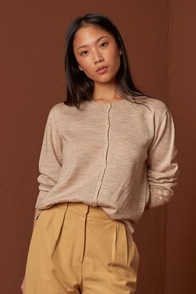 If you are looking for a quality basic sweater, you are in luck you have found it! This one is made of 100% merino wool. It has a round neck and features a half placket button closure. Its square cut makes it loose and comfortable. Style AX481.