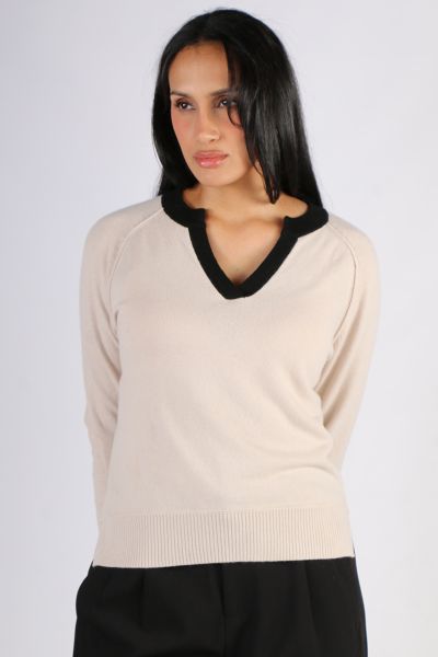 The Madly Sweetly Runaway Sweater is a V neck sweater in a cashmere, merino blend, featuring a contrast v neckline and cuffs with exposed seams, and side splits. MSK2515.
