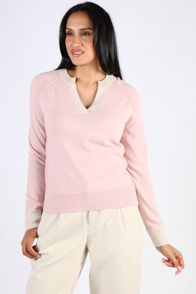 The Madly Sweetly Runaway Sweater is a V neck sweater in a cashmere, merino blend, featuring a contrast v neckline and cuffs with exposed seams, and side splits. MSK2515.
