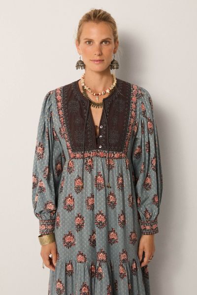 A dress that is bound to get you compliments, this Allegra dress does just that. The dress in a rich hand block printed textile in water lillies motifs all over, has a contrast panel, full sleeves with gathered details and the maxi length that sashays wit