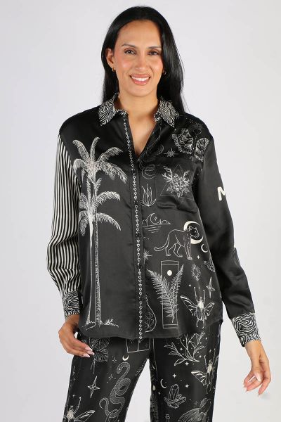 Black, long sleeve shirt with collar and cuffs in our Black Magic print. Six button front closure. Print is in white. Collar and cuffs are zebra striped. Front of the shirt has two palm trees on one side and lots of graphics on the other such as a leopard