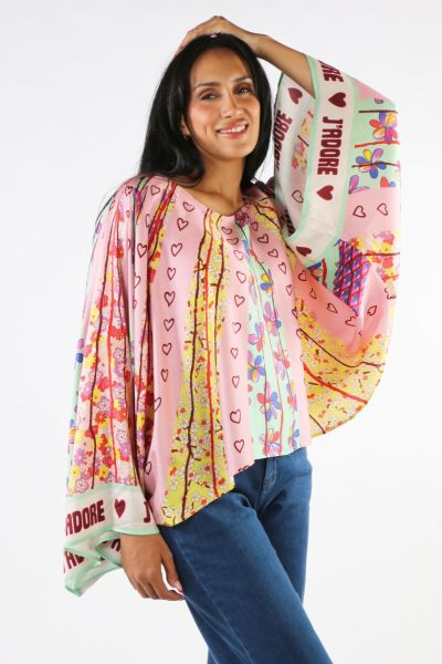 Flowry caftan shirt in our Twisted Love print is predominantly pink, yellow and green. Sleeves are wide, and the neck is rounded. Print is vertical hearts, stripes and flowers. It reads JADORE all along the cuff. Very pretty with our Bailey track pants.
