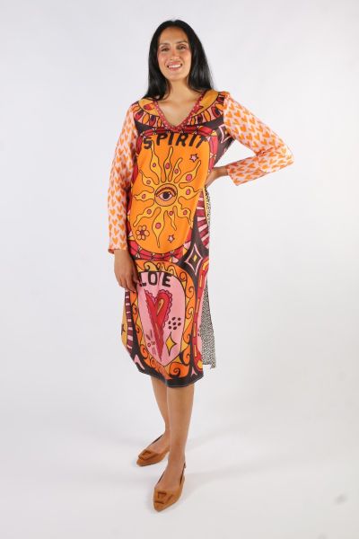 Long sleeve super vibrant long V neck dress with side slits in our Sunset print. Dress features two large retro graphics. One says SPIRIT with a sun with an eye in the middle. The other reads, LOVE with a heart. Primary colors are orange, pink, red , yell
