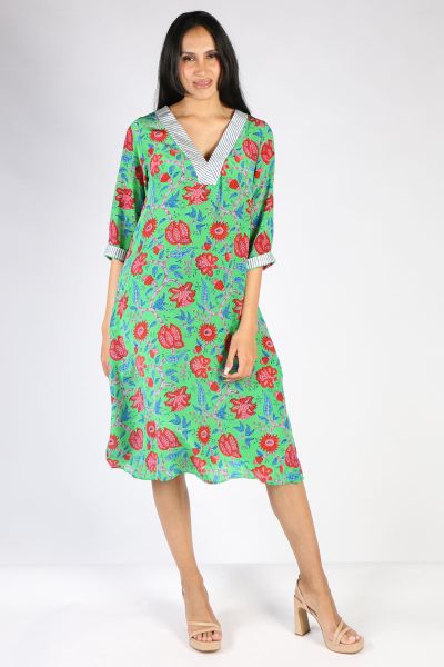 Florals are the perfect print for the season to add a dash of print to the chill season. The knee length dress features a floral print on a navy field in silk crepe de chine. A V neck gives you a leaner look and on trend flared sleeves add in that perfect