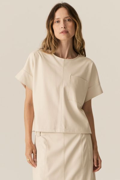 Get the perfect minimalist look with this Pol Belmond top that is all sorts of Scandi fab. In a faux leather, the short sleeves and waist length top has a roudn neck and front pocket detail. Pair it up with the matching skirt for that self assured look th