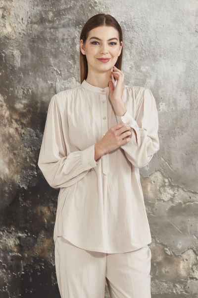 Tumbled satin shirt with Mandarin collar and front button placket. Back yoke. The bracelet length sleeve has soft gathers at the shoulder and button cuff. The Seattle shirt falls below the hip with a curved hemline. Mandarin collar, Back yoke, Curved heml
