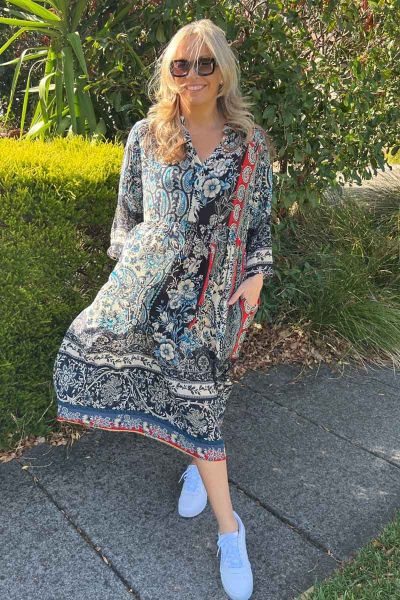 A fun printed dress takes you from easy to go vibes to brunch to cocktails. In an overall symphony of prints that Lula life is known for, this printed viscose dress with button tab sleeves, button front and falling just at your knees. Style it with easy g