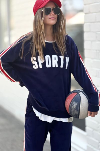 New slouchy sporty velour sweat in navy with stripe tape down each sleeve and Sporty chenille applique on the front. Looks great worn with the matching tracky pants or back with casual jeans! The same super soft, luxe velour as last year! Style H106.