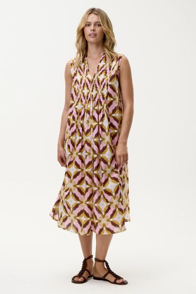 The Tobago Tommy Dress from oneseason captures the carefree essence of sun drenched days with a distinctly feminine edge. Crafted from lightweight, breathable cotton, this sleeveless silhouette is designed with a flattering V neckline and delicate pintuck