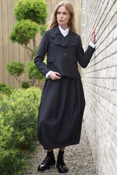 Commanding attention with its tulip silhouette, the SUIT CAMP Skirt is a modern take on tailored dressing. Crafted in SUITS UP fabric, this panelled design features curved seam panels that tuck inwards for a flattering drape, while a fixed waistband with 