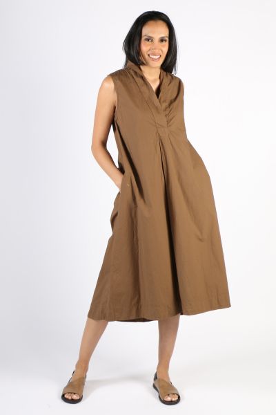 This cotton sleeveless dress is perfect to throw on when you want to look stylish but don't have the time to plan a whole look. The silhouette of this dress is unique with a deep collared V-neck, functional pockets and a slight high low hem. Style this wi