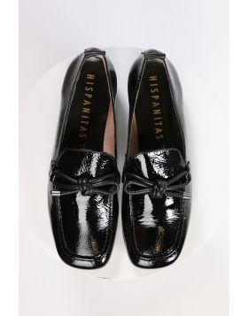 An elegant square toe moccasin made from a soft leather upper with a leather bow embellishment over the instep. Slip on and off with ease. Perfect for work, or for an elevated casual look. European sizing. Made in Spain. Leather upper, microfibre lining, 