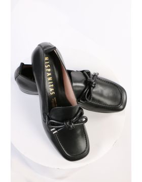 An elegant square toe moccasin made from a soft leather upper with a leather bow embellishment over the instep. Slip on and off with ease. Perfect for work, or for an elevated casual look. European sizing. Made in Spain. Leather upper, microfibre lining, 