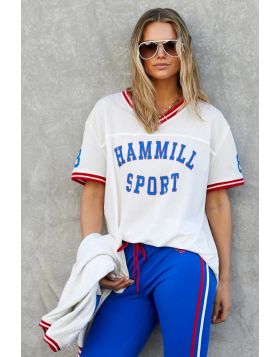 New Hammill Sport mesh tee brings a classic athletic feel, featuring bold collegiate letters and contrast stripe trims that give it that vintage game day energy. Lightweight, breathable textured mesh with front Hammill Spot and 74 print on the back.