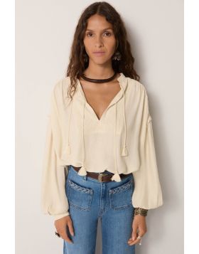 The Casablanca Muse Vega Blouse by Maison Hotel is a perfect laid back boho chic shirt. The embroidered diamond viscose shirt has drop shoulder, frilled trim, full peasant sleeves, a front open neck and a relaxed fit. The ivory shirt is your perfect go to