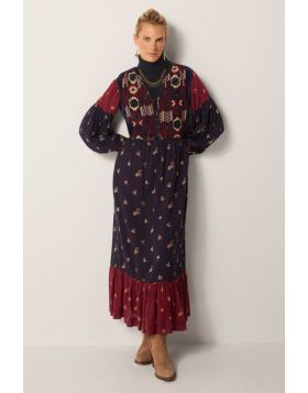 A headturning stunner of a dress by Maison Hotel is a perfect statement, easy and relaxed for this season. The embroidered long dress in tones of navy and red has long sleeves and finished with a frilled hem. The Maxi Length and frilled finish gives it an
