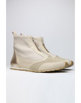 Sleek and sophisticated, this Istra Sneaker Boot by Zeta is a perfect go to for the season. The soft wedge boot has a front zip top in a combination of nylon and leather. Style this Sneaker boot with separates or add an edge to your dresses. 