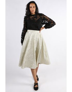 A champagne colored midi skirt made from high-quality, textured material with a crinkle and metallic finish. The skirt flows softly with every step, adding an elegant lightness to your look. The flowing A line silhouette and sophisticated surface make it 