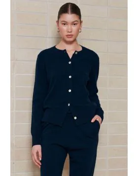 Crafted from pure, raw cashmere fibers, sustainably sourced , this essential cardigan epitomises eco luxury at its finest. This cardigan is the ultimate wardrobe essential, offering unparalleled comfort and timeless style. Its classic crew neck and delica