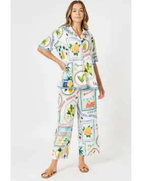 Celebrate la dolce vita in style with The Amalfi Pant, inspired by the charm and colour of the Italian coastline. Featuring a playful postcard and stamp print with limes, beach umbrellas, and coastal motifs, these pants bring the spirit of summer holidays