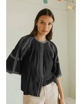 Effortless boho chic meets everyday comfort. Crafted from lightweight, breathable cotton, this shirt features beautiful contrasting ethnic embroidery that adds a touch of artisan charm to your wardrobe. Romantic bell sleeves, delicate shoulder pleats, and
