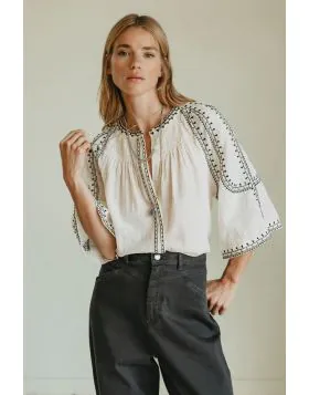 Effortless boho chic meets everyday comfort. Crafted from lightweight, breathable cotton, this shirt features beautiful contrasting ethnic embroidery that adds a touch of artisan charm to your wardrobe. Romantic bell sleeves, delicate shoulder pleats, and