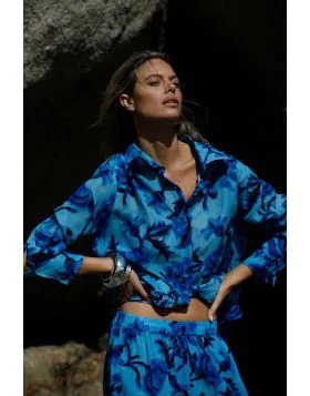 The Claudia Shirt is a relaxed button down style with a laid back, oversized fit. Featuring a classic collar, long sleeves, and a gently curved hem, it s an easy throw on piece designed for effortless holiday dressing. Pair with the Isla Pants for a coord