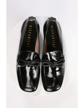 An elegant square toe moccasin made from a soft leather upper with a leather bow embellishment over the instep. Slip on and off with ease. Perfect for work, or for an elevated casual look. European sizing. Made in Spain. Leather upper, microfibre lining, 