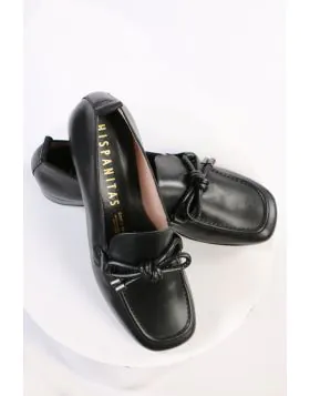 An elegant square toe moccasin made from a soft leather upper with a leather bow embellishment over the instep. Slip on and off with ease. Perfect for work, or for an elevated casual look. European sizing. Made in Spain. Leather upper, microfibre lining, 