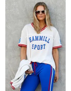 New Hammill Sport mesh tee brings a classic athletic feel, featuring bold collegiate letters and contrast stripe trims that give it that vintage game day energy. Lightweight, breathable textured mesh with front Hammill Spot and 74 print on the back.