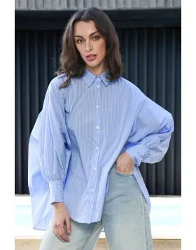 The Living the Dream shirt brings a fresh, edgy twist to casual dressing. With its effortless relaxed silhouette and contemporary high low hem, it flows with movement and attitude, perfect for layering or wearing solo. Featuring batwing, gathered sleeves,