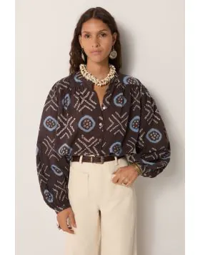100% cotton voile blouse, cut loose with a soft drape, patterned in hand dyed geometrics. Circles framed in sky blue and dotted crosses run across a dark ground, the irregularity of each mark carrying the imperfect rhythm of craft. The voile is airy and t