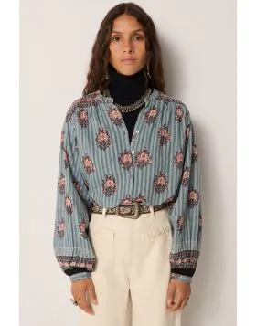 Cotton dobby with fine stripes, steady but soft to wear. The base carries depth, washed down like ceramic glaze. Printed floral medallions scatter across the blouse in reds and blues. Warm tones lift against cool ground, evoking age but with vibrancy.